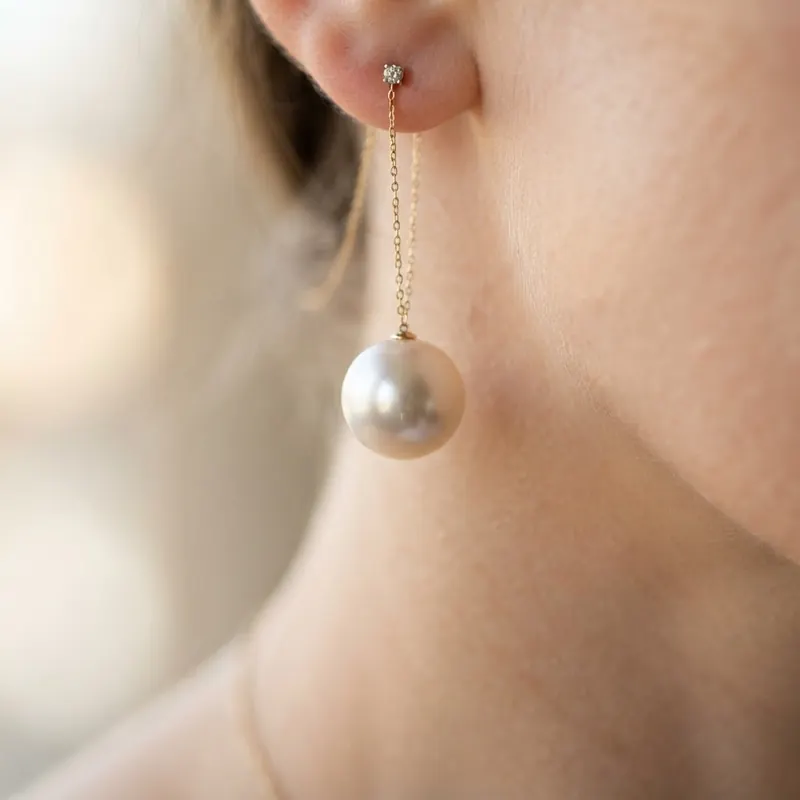 AI-generated macro: pearl earring against soft neck skin with creamy bokeh, jewelry advertising light